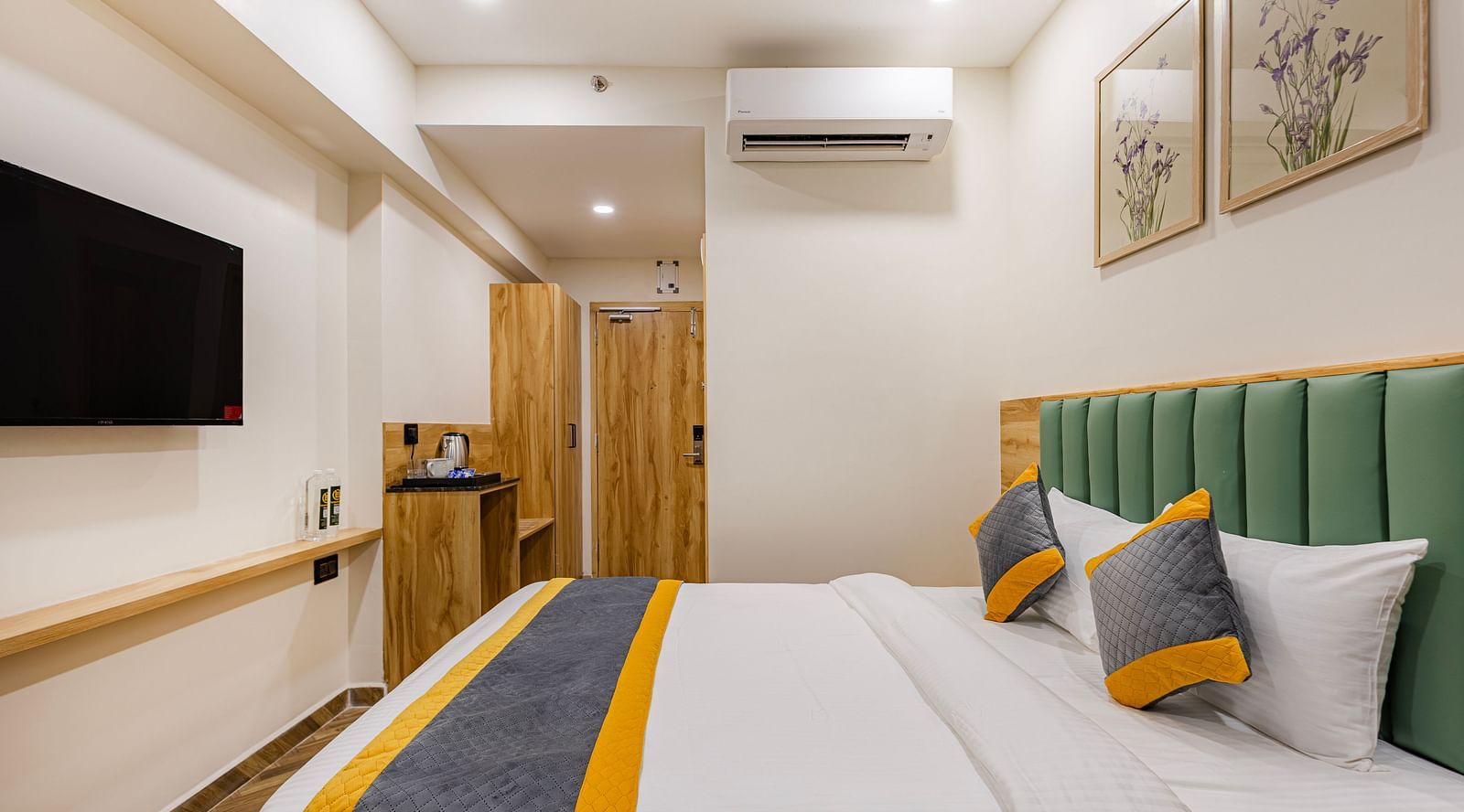 Lemonridge Hotels, KPHB | Hotel room with a bed, TV mounted on the wall, and a side table. Comfortable furnishings.